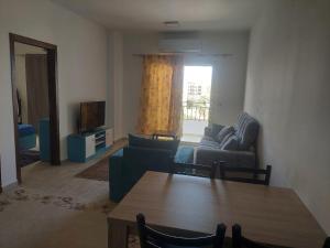 a living room with a couch and a table at Al makramia compound in Hurghada