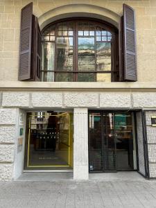 a building with two entrances to a store at The Loft Hostel La Pedrera in Barcelona