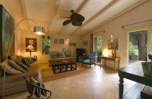 a living room with a couch and a ceiling fan at Domaine Panciarella in Saint-Florent