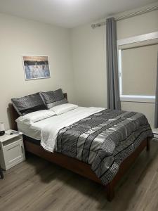 a bedroom with a large bed with a window at Docker in Timberlea