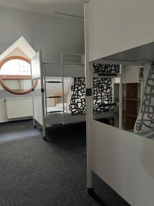 a room with two bunk beds and a mirror at Hostel John Galt in Brno