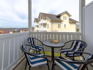 a patio table and four chairs on a balcony at Wohnpark Stadt Hamburg - Apt. 27 in Binz