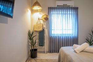 a bedroom with a bed and a window at כפר הנופש קיבוץ גדות Kibbutz Gadot Galilean Resort in Gadot