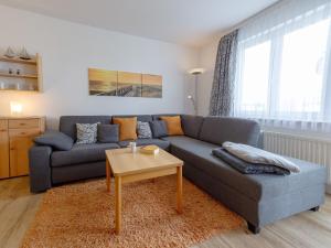 a living room with a blue couch and a table at Wohnpark Stadt Hamburg - Apt. 27 in Binz