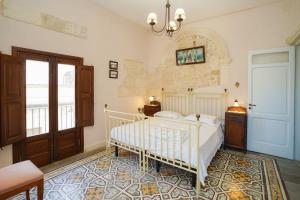 a bedroom with a white bed in a room at Pietra Viva in Martano