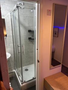 a glass shower in a bathroom with a sink at Quirky Oasis Anfield in Liverpool