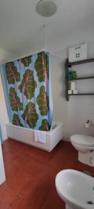 a bathroom with a toilet and a shower curtain at Casa Pedroso in Noja