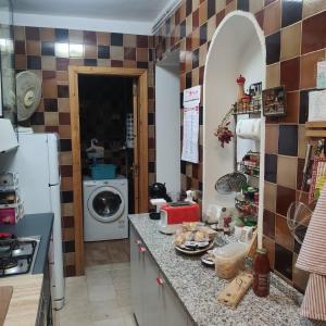 a kitchen with a counter with a washing machine at Villa roverella in Cassano delle Murge