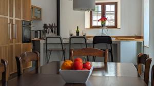 a kitchen with a table with a bowl of fruit on it at Molino Viejo de Salar in Salar
