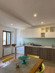 a kitchen with a wooden table and a tableasteryasteryasteryasteryasteryasteryastery at Casa Nonna Rina in Chiusdino