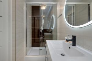 a bathroom with a shower and a white sink at Beautiful Apartments Herberta by Rent like home in Świnoujście