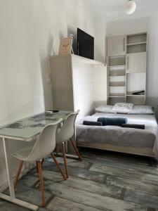 a bedroom with a bed and a desk and chairs at BEM by Small Home Budapest in Budapest