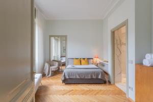 1 dormitorio con 1 cama con almohadas amarillas en Garibaldi's Balcony by Rent All Como, en Como