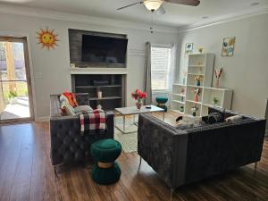a living room with two couches and a tv at Charming Oasis in Worthville