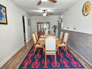 a dining room with a table and chairs on a rug at Charming Oasis in Worthville