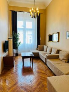 una sala de estar con un sofá y una mesa en Main Market Square Apartments, en Cracovia