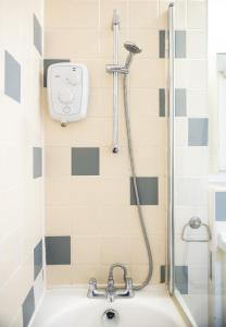 a shower in a bathroom with a bath tub at NEW - Serviced Apartment - Exel & O2 & Canning Town - home away from home in London