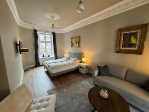 a living room with a couch and a bed at Art Apartments in Hamburg