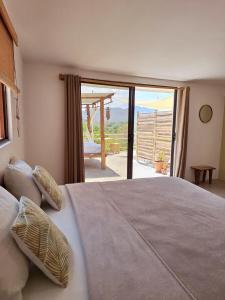 a bedroom with a bed with a view of a patio at La Casa del Conde in Playa Naranjo