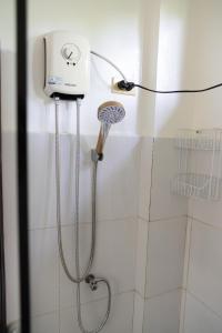 a shower with a blow dryer in a bathroom at Amara Pool & Villas 180Mbps Central location in General Luna