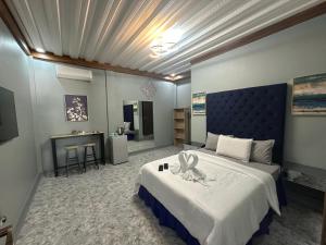 a bedroom with a large bed and a desk at Lawson’s Beach Resort in San Juan