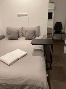 a bed with a table on top of it at Shared Apartment in Central London in London