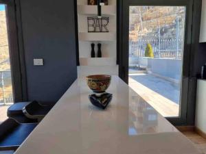 a white counter with a vase sitting on top of it at Modern 2BR Duplex in Afqā