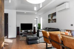 a living room with a couch and a table at Flott moderne hus langs elven! in Fredrikstad