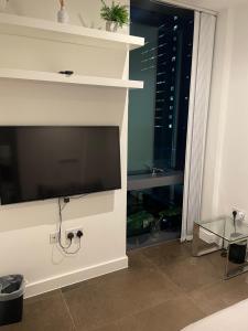 uma sala de estar com lareira e televisão de ecrã plano em Shared Apartment in Central London em Londres