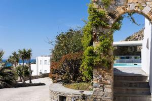 a stone archway with a pool and a house at Villa Bella. Tranquil, exclusive, 4 bed, sea views in Naxos Chora +43 photos