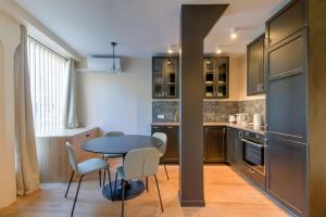 a kitchen with a table and chairs in a room at Appart 6Pers # Père Lachaise # Voltaire # Paris 11 in Paris