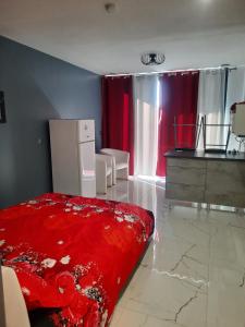 a bedroom with a red bed and red curtains at Esperanza in Cap d'Agde