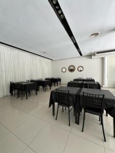 a dining room with black tables and black chairs at GRAN HOTEL VILLAGUAY in Villaguay