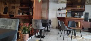 a bar with a bunch of chairs in a restaurant at Hotel Luxembourg in Lourdes