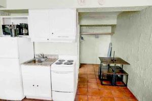 a kitchen with white appliances and a table in it at Oceanfront. Ground Floor. Easily Accessible. in Myrtle Beach