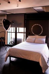 a bedroom with a large bed with a camera at Indie Universe Creative Hotel in Medellín