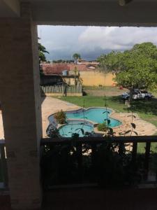 a view of a swimming pool from a balcony at Pousada Praia Do Farol in Alcobaça