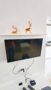 a computer monitor with two deer figurines on a wall at Cozy & Easy living Condo 65/79 in Kathu