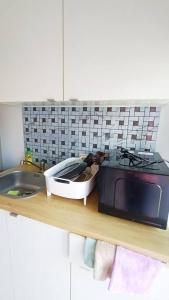 a kitchen counter with a microwave and a sink at Cozy & Easy living Condo 65/79 in Kathu