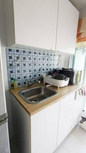 a kitchen counter with a sink and a microwave at Cozy & Easy living Condo 65/79 in Kathu