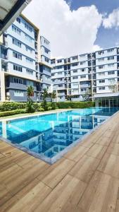 a swimming pool in front of a large building at Cozy & Easy living Condo 65/79 in Kathu