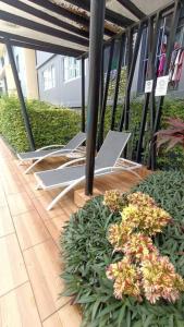 a group of chairs sitting on a patio at Cozy & Easy living Condo 65/79 in Kathu