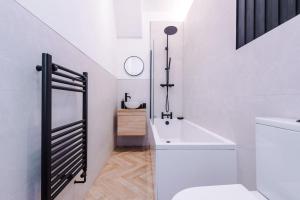 a white bathroom with a toilet and a sink at 4 Bedroom House Eccles in Manchester