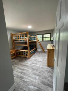 a room with two bunk beds and a staircase at Private 4 Bedroom Home with a hot tub in Caseyville