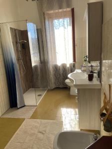 a bathroom with a shower and a toilet and a sink at Affittacamere La CRICOVA di Iulia in Santo Stefano