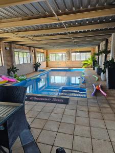 a swimming pool in a house with a pool at Cameo Inn Motel in West Wyalong