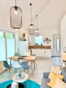 a kitchen and living room with a table and chairs at Gemütliches Ferienhaus mit Pool DIREKT am Deich an der Nordsee, Nähe Center Parks in Sehestedt