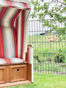 a porch with a bed with a view of a field at Gemütliches Ferienhaus mit Pool DIREKT am Deich an der Nordsee, Nähe Center Parks in Sehestedt