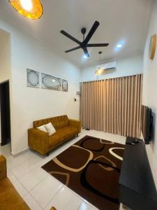 a living room with a couch and a ceiling fan at Hazzani Homestay KLIA in Banting