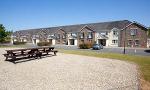 a park bench in front of a row of houses at Knightsbrook Hotel Courtyard Accommodation in Trim